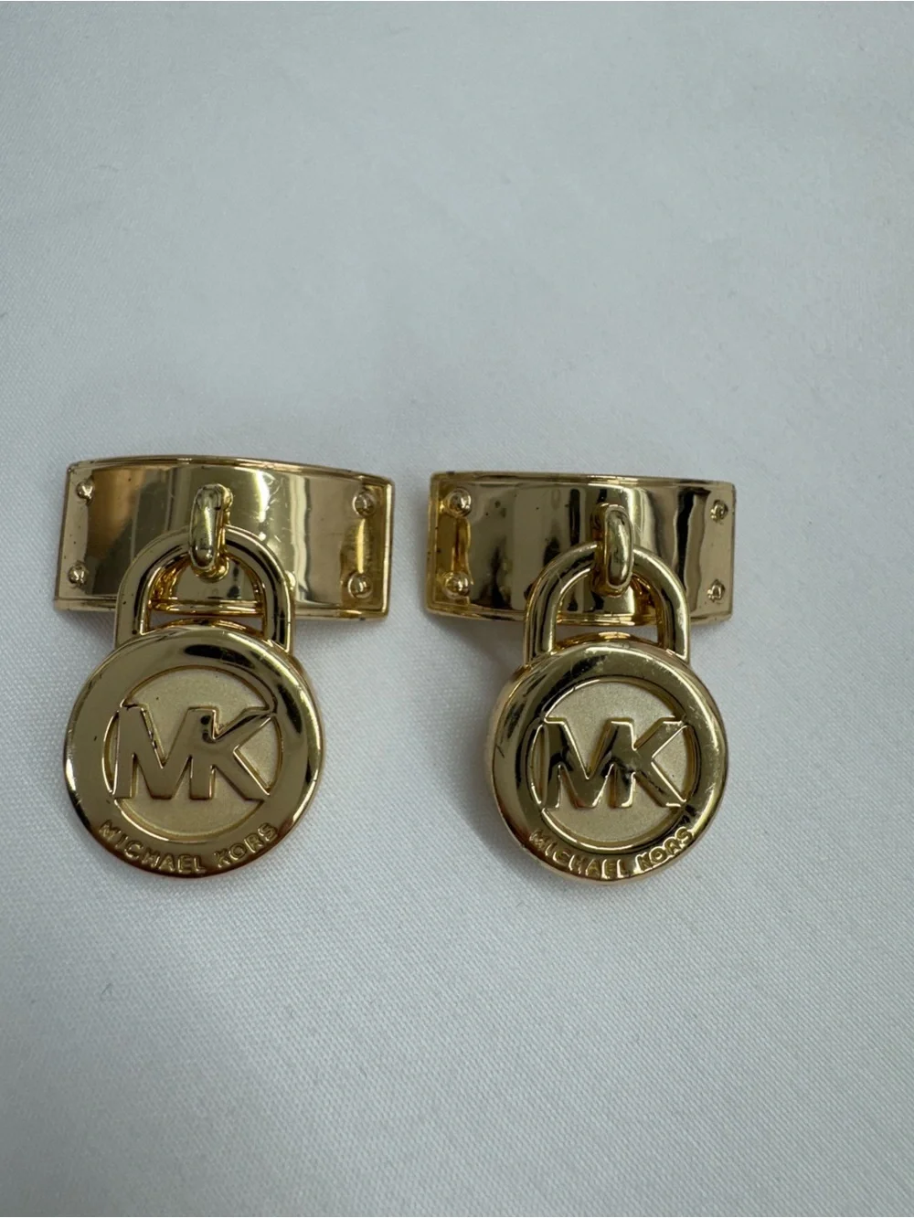These are golden-tone replacement hardware pieces by Michael Kors .